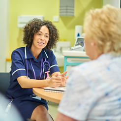 Photo of a nurse speaking with a patient