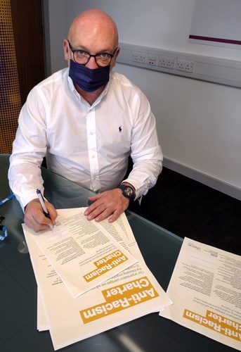 Sean Leahy signing the anti racism charter