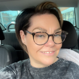 Picture of Fiona. Fiona has short hair and wears glasses.