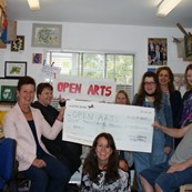 Photo of Open Arts volunteers holding a cheque for funding