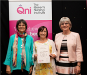 Photo of three women celebrating the Queen's award