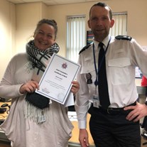 Susan Inglis with a police officer, holding her street triage award