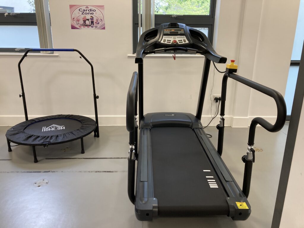 A new medical treadmill with support handles and a mini safety trampoline in the cardio rehabilitation zone at St Margaret's Hospital.