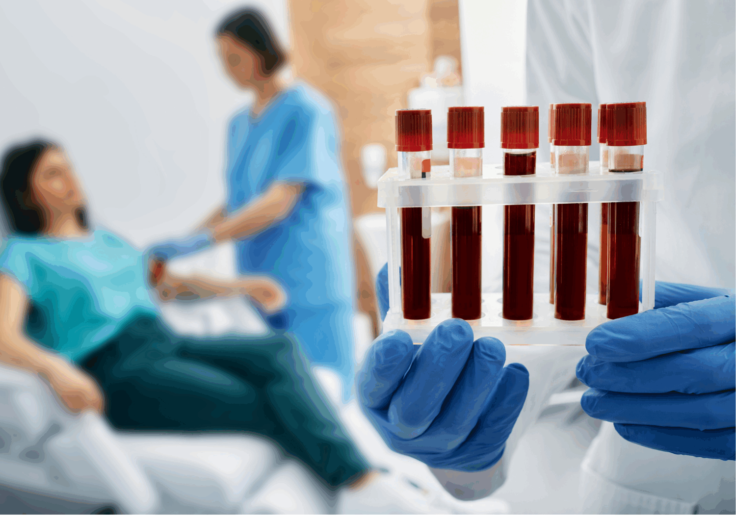 Woman having a blood test. Focus on 5 test tubes filled with blood samples.