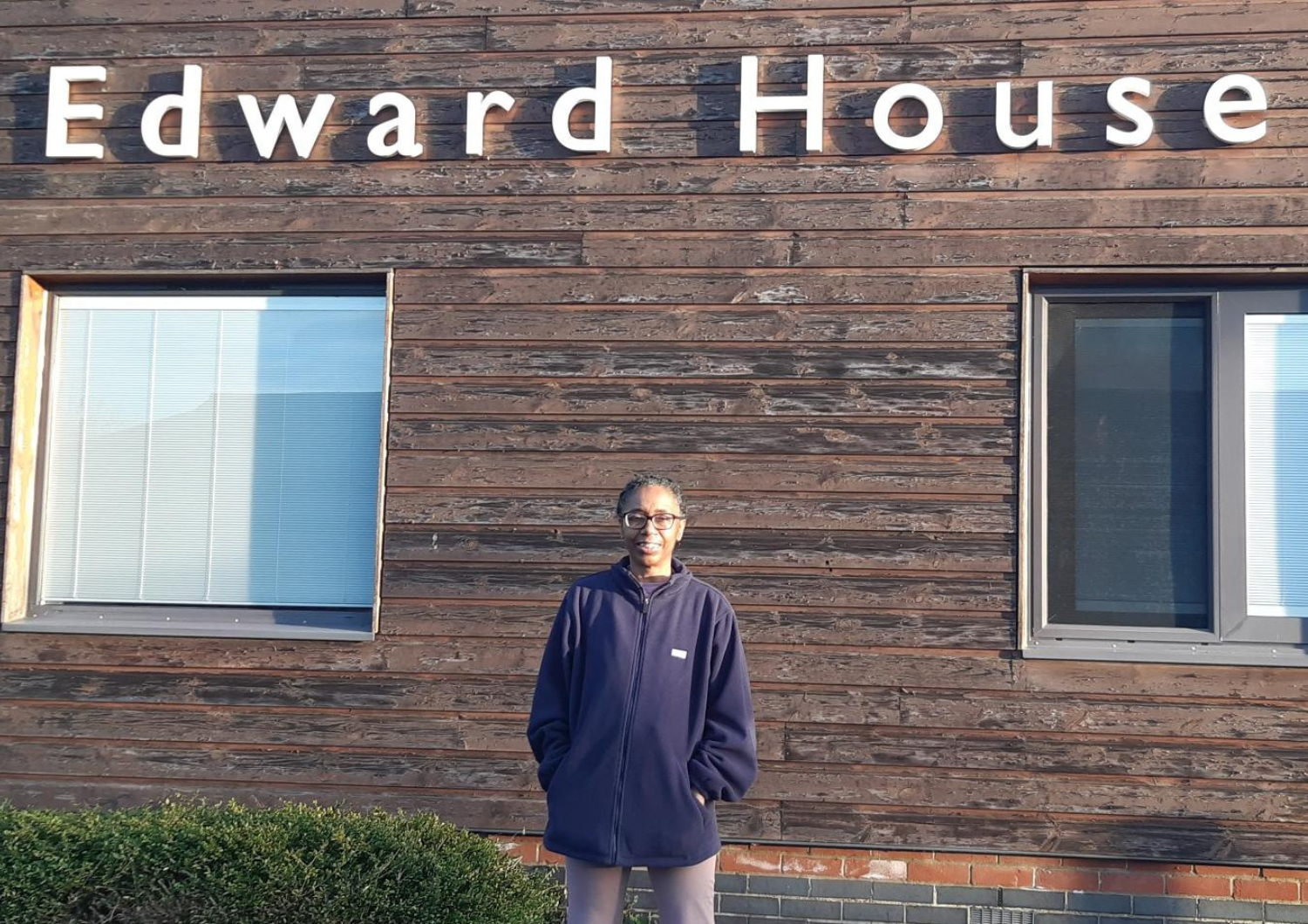 Peer worker Rosealine standing outside Edward House