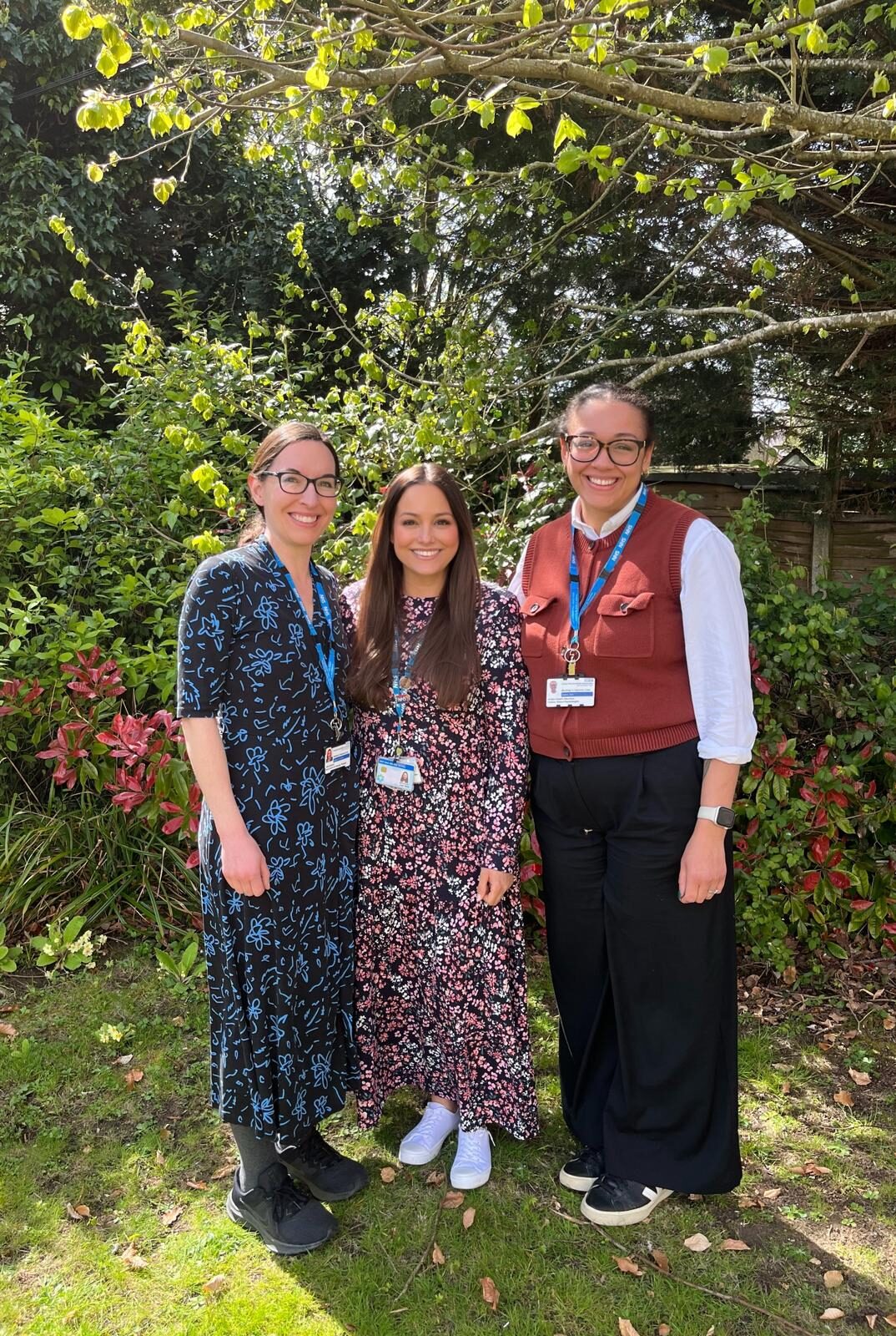 Three smiling NHS workers from the Stroke Rehab team