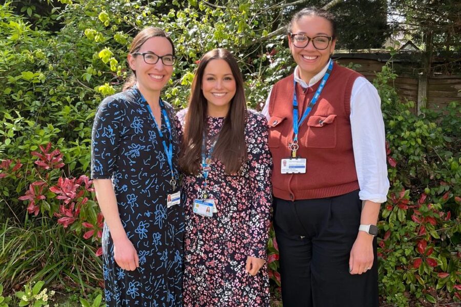 Three smiling NHS workers from the Stroke Rehab team