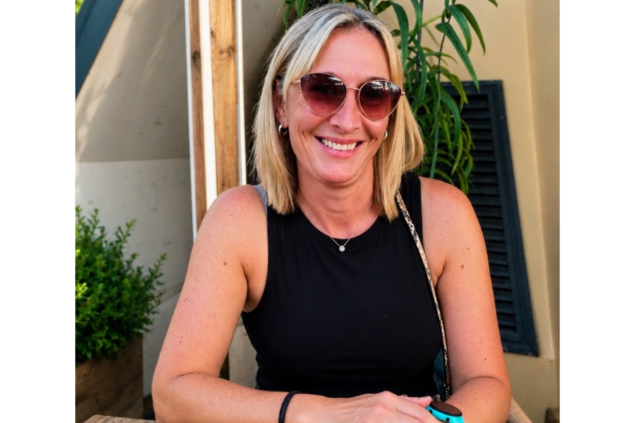 Portrait of EPUT medical secretary Sarah Parker smiling outdoors while wearing sunglasses and a black sleeveless top.