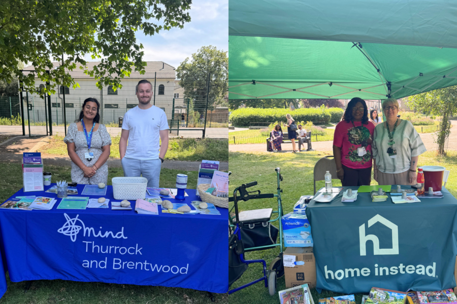 Side-by-side photos of information stalls at an outdoor wellbeing event: the left shows representatives at a "Mind Thurrock and Brentwood" table, and the right shows staff at a "Home Instead" gazebo booth.
