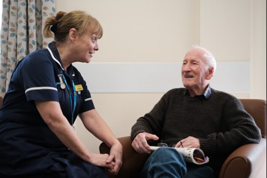 Nurse talking with an elderly patient