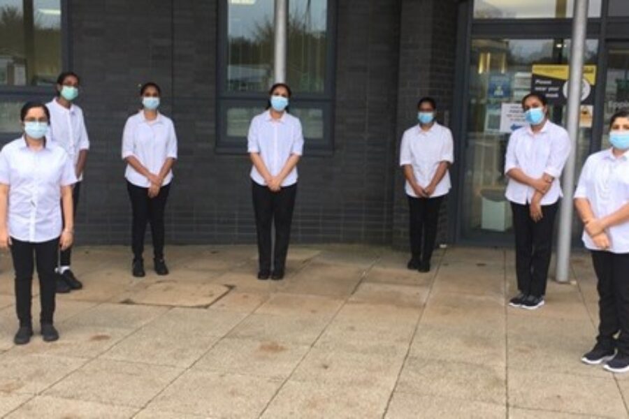 Indian nurses who joined the Trust, having their photo taken outside of St Margaret's Hospital.