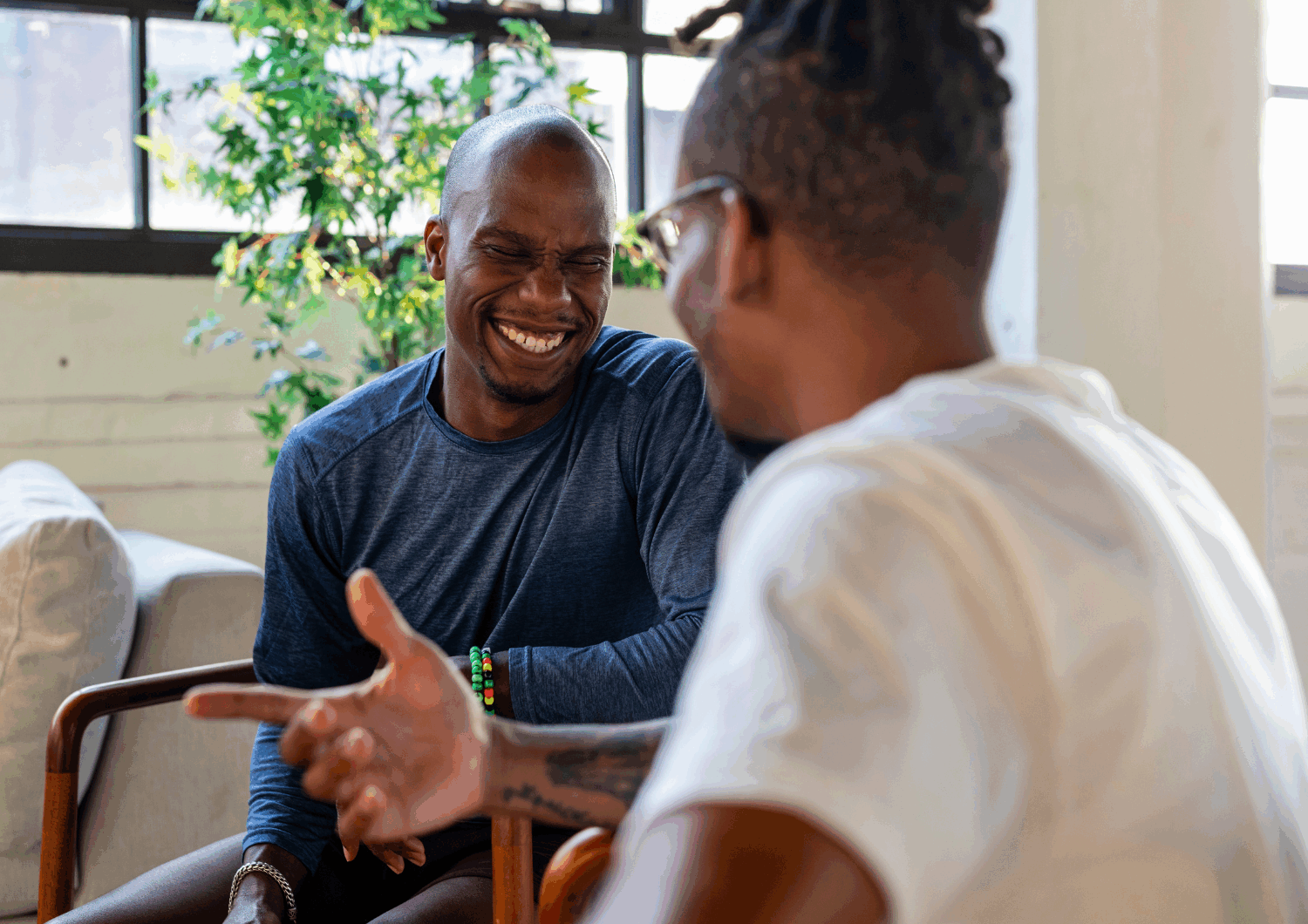 Two men sitting and talking with each other