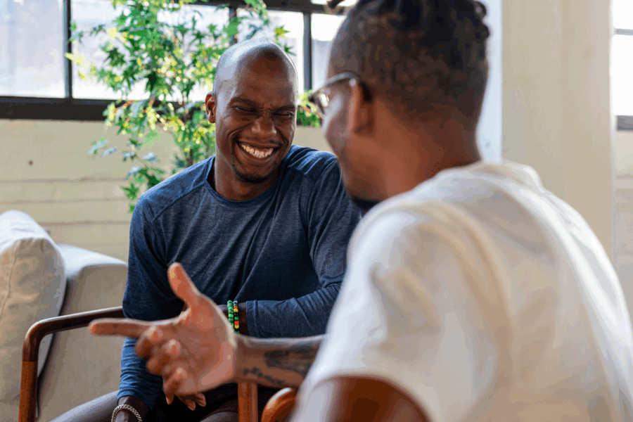 Two men sitting and talking with each other